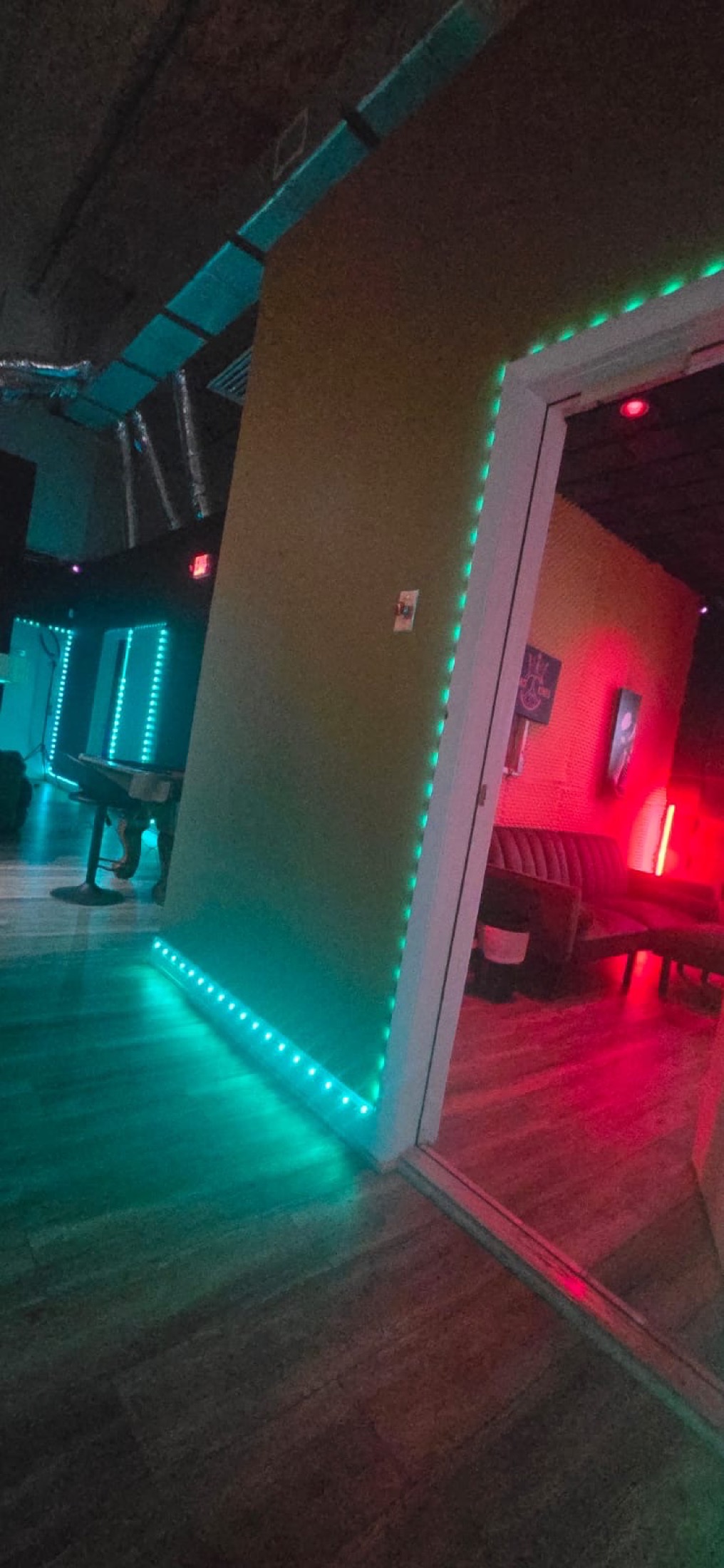 Teal-lit studio entry at Peace King Studios
