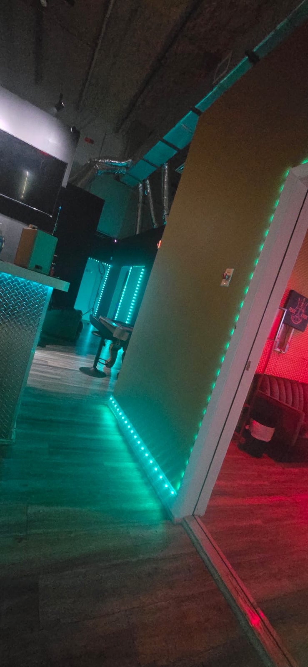 Wide teal and red studio entry at Peace King Studios